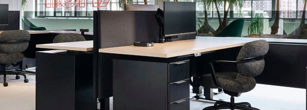 Office view with Morrison Hannah™ Chair by Knoll. Ergonomic task chair in speckled gray fabric with black frame.