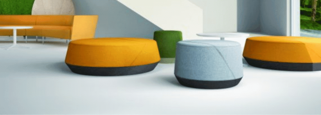 Modern AUTO-DRAFT modular seating. Colorful, round ottomans with fabric tops and dark bases. Perfect for collaborative spaces.