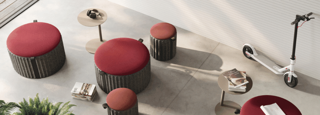 AUTO-DRAFT: Modern red-topped ottomans and side tables create a stylish, flexible seating arrangement.