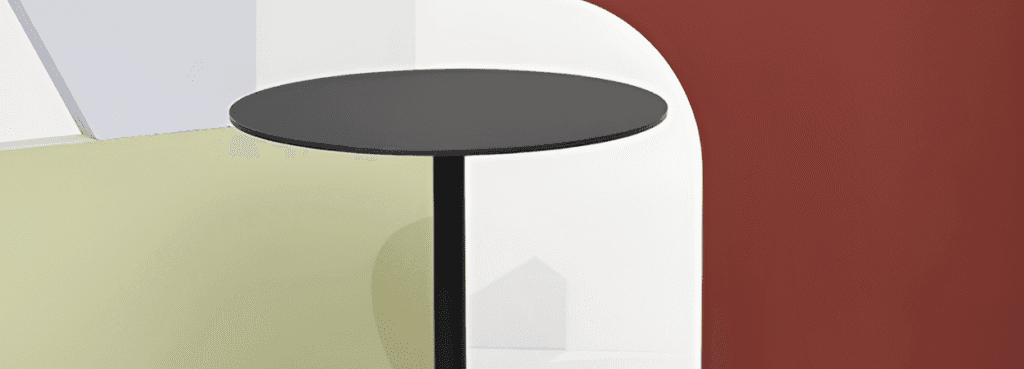 Minimalist black Flink Table by Infiniti. Painted steel with round base, ideal for bistros and outdoor spaces.