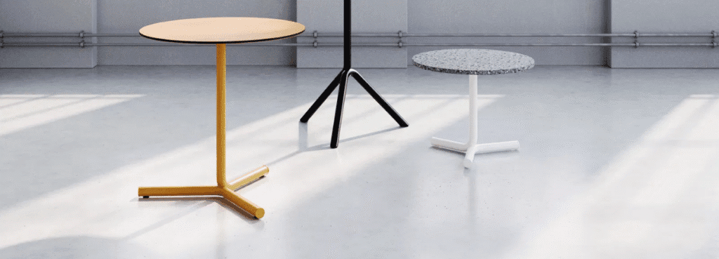 Three Jit Coffee Table designs in yellow, black, and white with round tops.