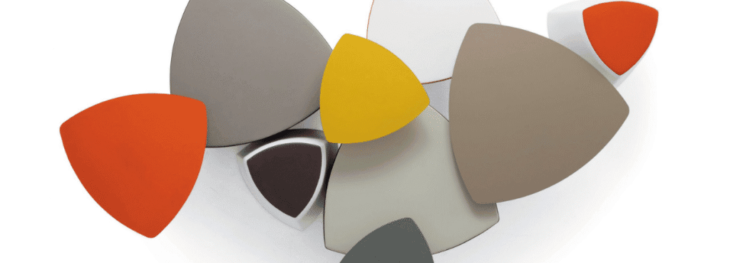 Modern Kensho pouf. Triangle-shaped seating in orange, yellow, gray, and brown.