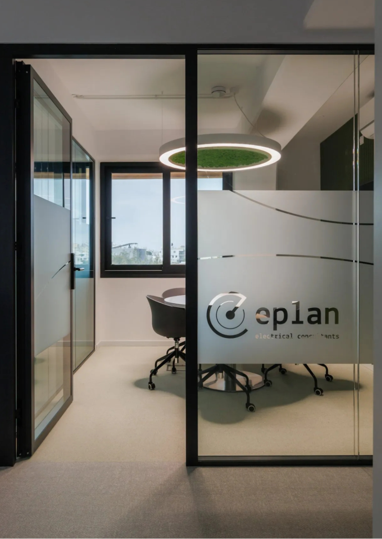 ePlan Consultants Cyprus office interior, showcasing a modern conference room with the 'ePlan' logo on frosted glass.