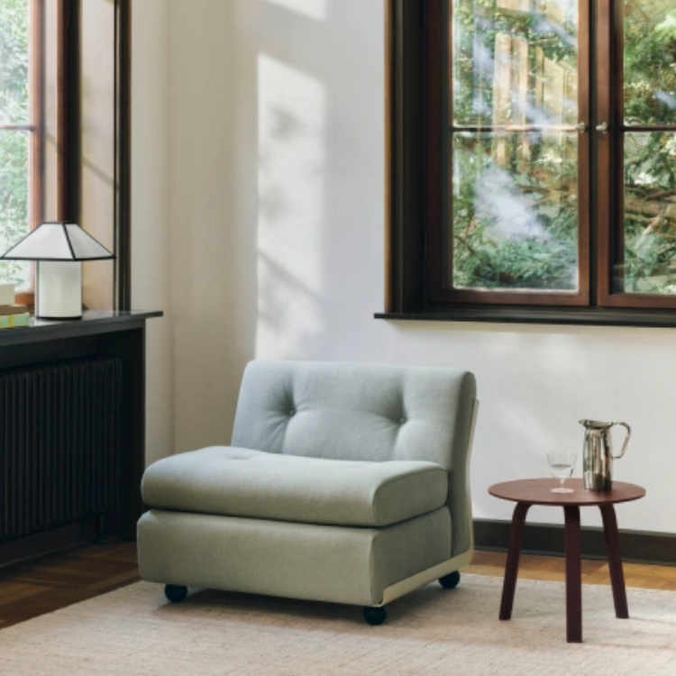 Amanta 1 Seater in soft green fabric, featuring a modular design with tufted backrest in a bright, modern interior.