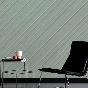 Close-up of a minty green Chevron Carved Acoustic Panel with clean diagonal grooves mounted on a modern wall.