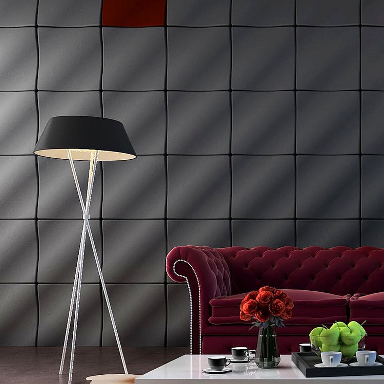 Crest &amp; Trough dark grey modular wall panels creating a rhythmic undulating texture behind a velvet sofa.