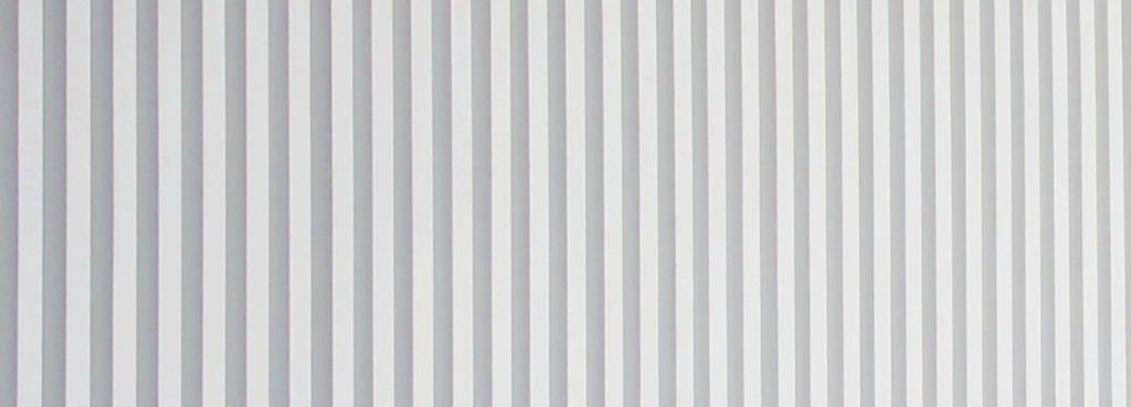 Close-up of a white Fine Reeded Acoustic Panel featuring uniform vertical ribs in a minimalist, modern style.