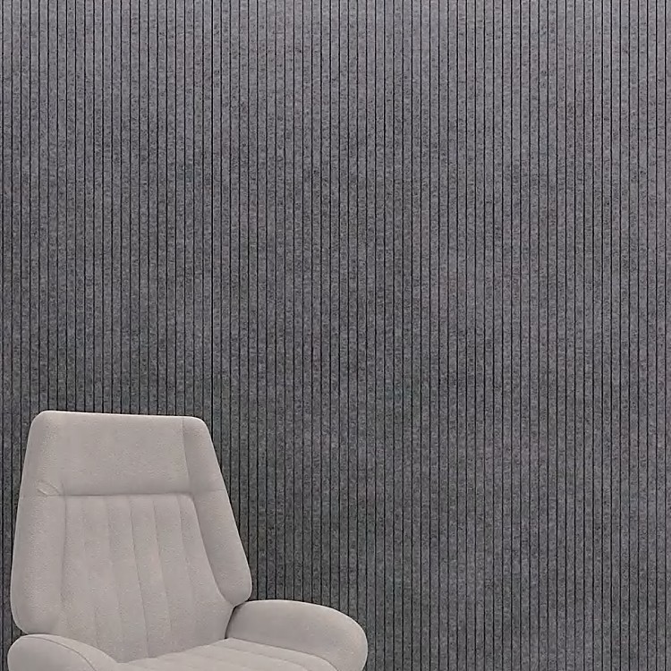 Charcoal grey Fluted Acoustic Slat Panel surface showing vertical felt ribs and narrow grooves behind a beige chair.