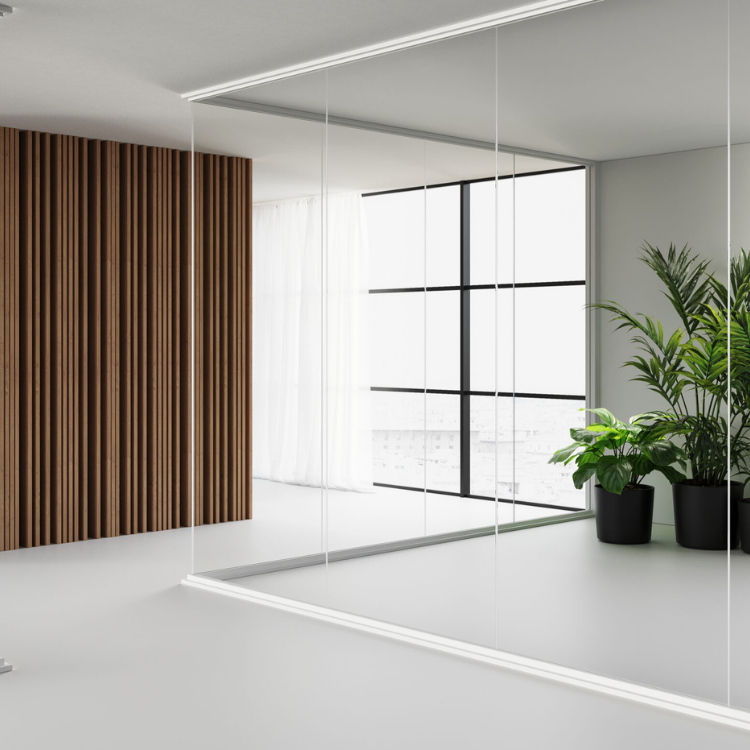 Infinity frameless glass partition system with wooden slat wall and minimalist modern interior design.