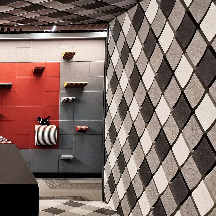 Keygrid Mini acoustic felt tiles create a dynamic, raised geometric texture on a modern interior wall.