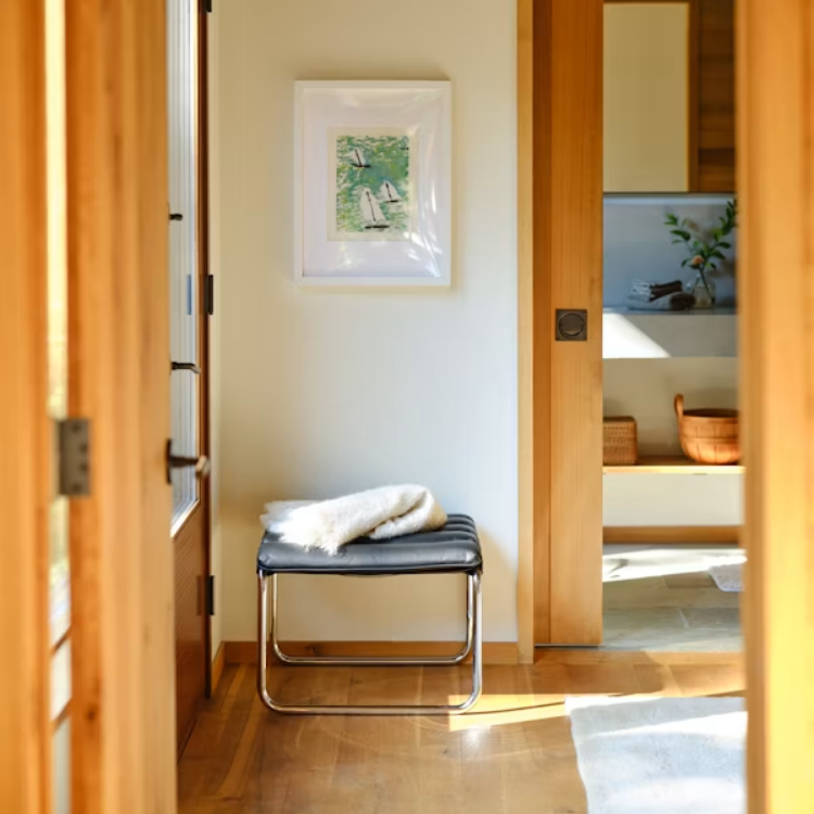 MR Stool with polished chrome tubular frame and black quilted leather cushion in a bright modern home entryway.
