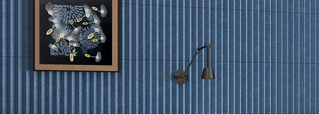 Blue Modu V acoustic wall panels featuring textured felt ridges with a V-shaped linear design.