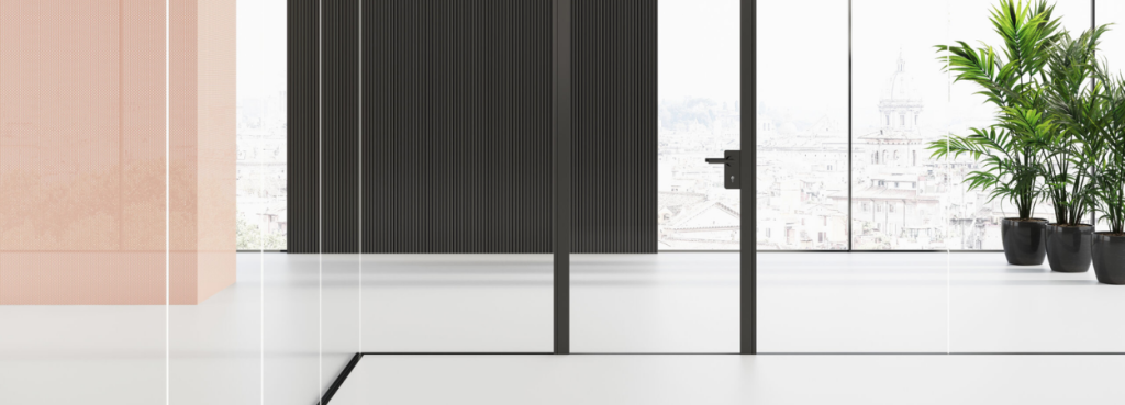 Mood MN glass partition wall featuring a central door with a black handle against a soft pink and ribbed dark backdrop.