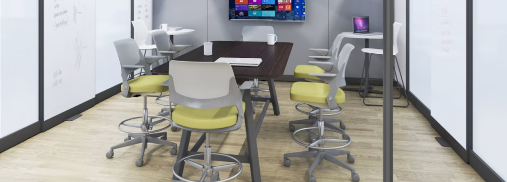 Multiple Ollo Stool units with lime green seats and grey frames arranged around a dark wood high-top meeting table.