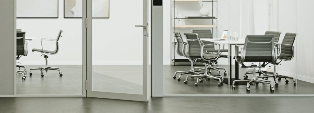 Pure AS System glass partition door creating a transparent divider between two modern, light-filled meeting rooms.