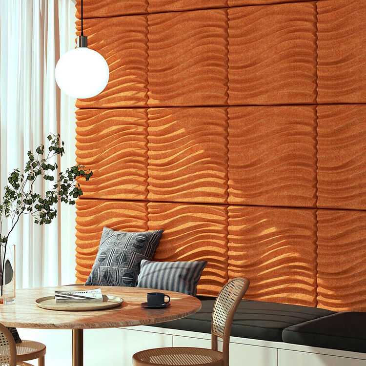 Vibrant orange Storm Wave acoustic wall panels with 3D undulating textures creating a bold, contemporary design feature.