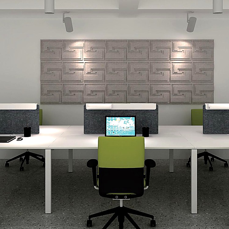 Town Tales grey acoustic wall tiles with recessed maze-like patterns mounted above a modern desk arrangement.